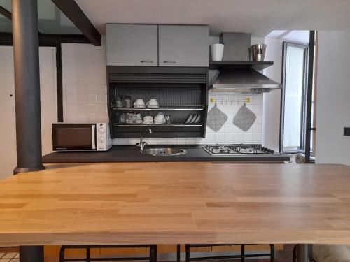 a kitchen with a wooden table in a kitchen at Lerici Home in Lerici