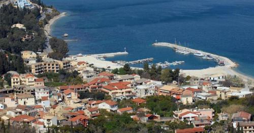 a town with a harbor and boats in the water at Gardelis Gardens in Benitses