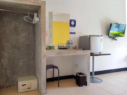 a kitchen with a counter and a refrigerator at Rawai Whale Resort in Rawai Beach