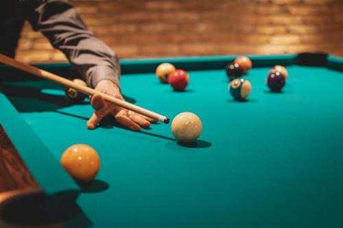 a man playing a game of pool on a pool table at Relais Almaranto in Calamandrana