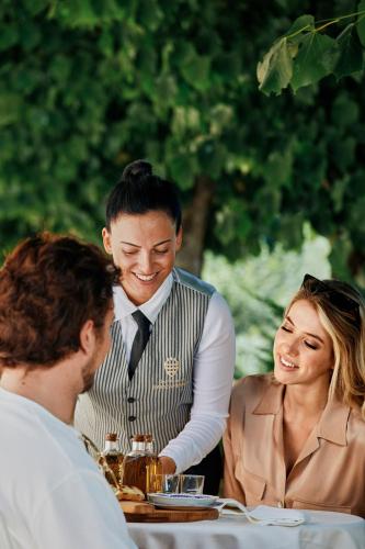 a man and a woman sitting at a table at Castello di Baccaresca in Branca