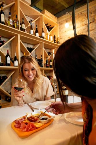 a woman sitting at a table with a plate of food at Castello di Baccaresca in Branca