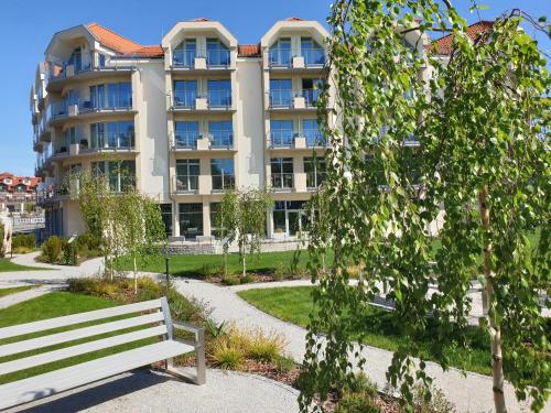 a park bench in front of a building at Hotel White in Krynica Morska