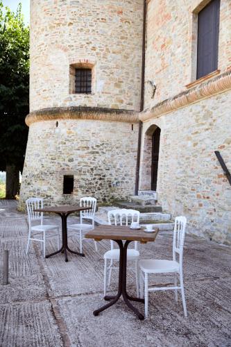 a table and chairs in front of a building at Castello di Baccaresca in Branca