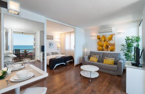 ein Wohnzimmer mit einem Sofa und einem Tisch in der Unterkunft Sur Suites Palmeras 5 in Fuengirola