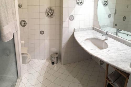 a bathroom with a sink and a toilet at Appartamento Arcobaleno in centro citta in Bergamo