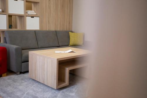 a living room with a couch and a table at SALAMANDRA Hotel in Banská Štiavnica