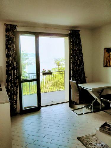 a room with a sliding glass door with a view of the ocean at Villa Relax in Stresa