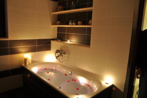 a bath tub with candles and lights in a bathroom at Porfyra's Island in Makry Gialos