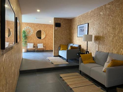 a living room with two couches and a living room with at Ninho Citadino Aveiro in Aveiro