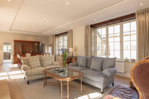 a living room with couches and a table at Farlam Hall Hotel & Restaurant in Brampton