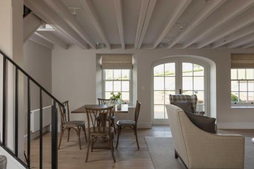 a dining room with a table and chairs at Farlam Hall Hotel & Restaurant in Brampton