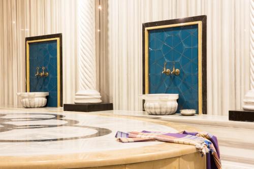 a room with two toilets and blue walls at Sunprime C-Lounge - Adult Only in Alanya