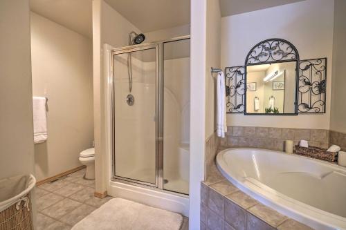 a bathroom with a tub and a shower and a toilet at Pet-Friendly Townhome with Hot Tub in Redmond! in Redmond