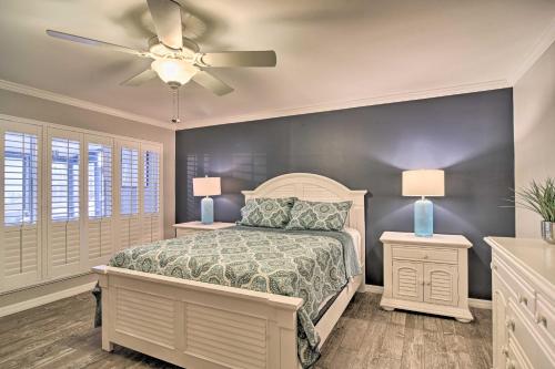 a bedroom with a bed and a ceiling fan at Elegant FL Condo with Pool Walk to Madeira Beach! in St Pete Beach