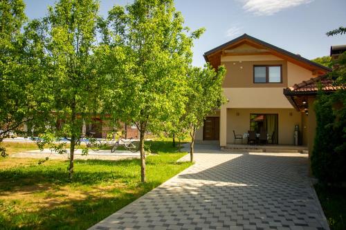 a walkway in front of a house with trees at Holiday Home Faruk in Račić