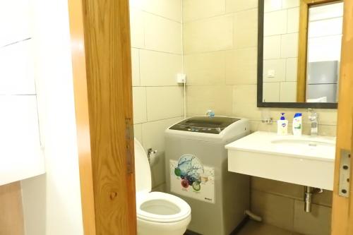 a small bathroom with a toilet and a sink at Executive Apartments In Bahria Heights in Rawalpindi