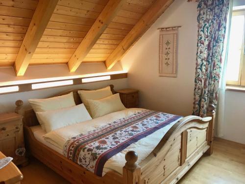 a bedroom with a wooden bed in a room at Marga`s Ferienwohnung in Lembach im Mühlkreis