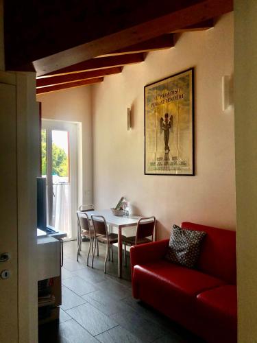 a living room with a red couch and a table at Antica Residenza I Ronchi Di Bellagio in Bellagio