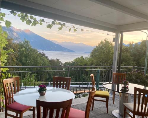 a porch with a table and chairs and a view at Antica Residenza I Ronchi Di Bellagio in Bellagio