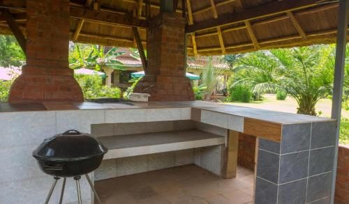 a outdoor kitchen with a grill on a patio at Edaala Comfort - B&B in Nairobi