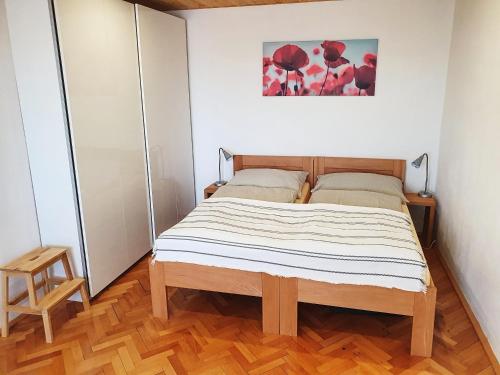 a bedroom with a bed in a white room at Apartmán Stožec in Stožec