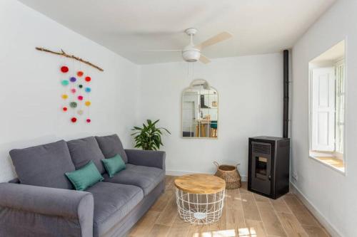 a living room with a couch and a table at La Casita de Piedra in Cercedilla