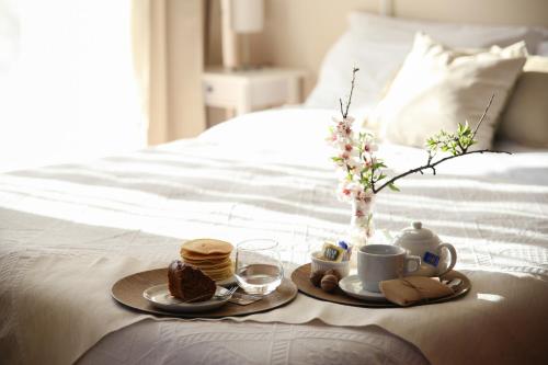 a tray of breakfast food on a bed at B&B Eyexei Domus in Agrigento