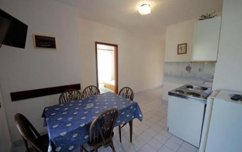 a kitchen with a table with a blue polka dot table cloth at APARTMENTS Vuković in Vrboska