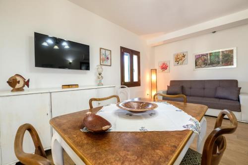a living room with a table and a couch at Villa Marzoni con Piscina Privata by HDSalento in Tiggiano