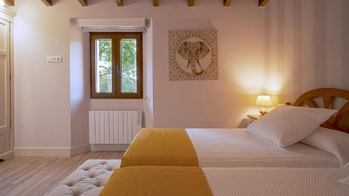 a bedroom with a bed and a window at Casa Portolago in Carballo