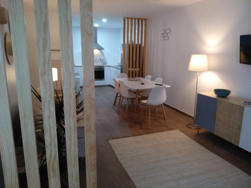 een woonkamer en eetkamer met een tafel en stoelen bij Apartamentos Areia e Mar Norte in Vila Praia de Âncora