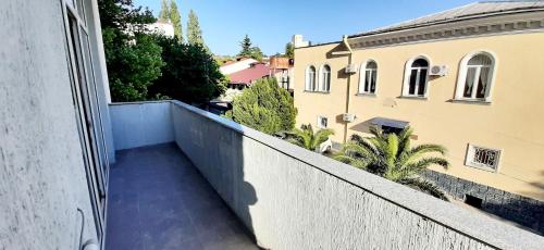 a balcony with a view of a building at Happy Stay Hotel in Kutaisi