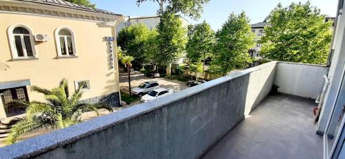 an apartment balcony with a view of a parking lot at Happy Stay Hotel in Kutaisi