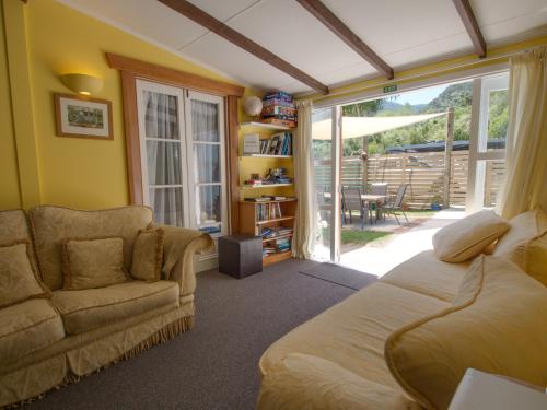 a living room with a bed and a couch at Anakiwa 401 in Anakiwa