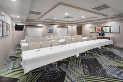 a conference room with white chairs and a podium at Holiday Inn Express Hotel & Suites Longmont by IHG in Longmont