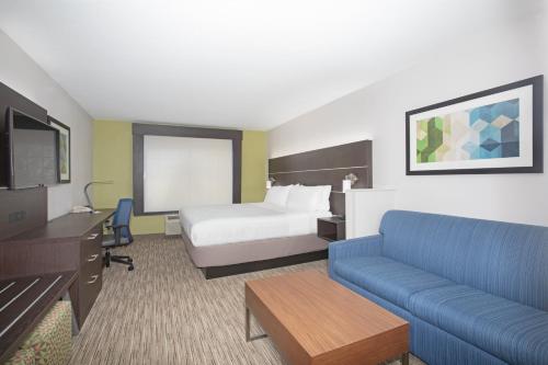 a hotel room with a bed and a couch at Holiday Inn Express Hotel & Suites Longmont by IHG in Longmont