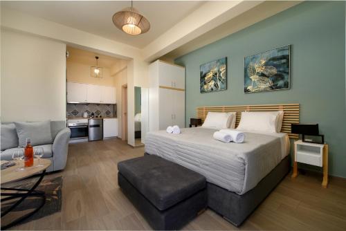a bedroom with a bed and a living room at Tessera Villas & Studios Collection in Gouvia