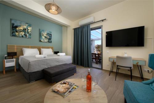 a bedroom with a bed and a living room with a table at Tessera Villas & Studios Collection in Gouvia