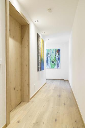 an empty room with two paintings on the walls at Atelier Garni Astei in Grossarl