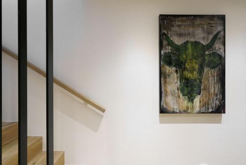 a painting of a cow on a wall at Atelier Garni Astei in Grossarl