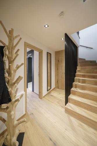a staircase in a house with a tree in the foreground at Atelier Garni Astei in Grossarl
