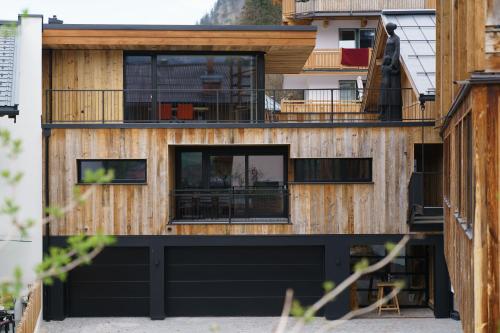 a house with a black garage at Atelier Garni Astei in Grossarl