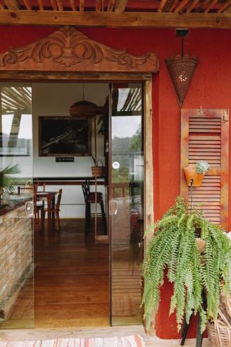an entrance to a house with a glass door at Sapê Guest Hotel in Praia do Rosa