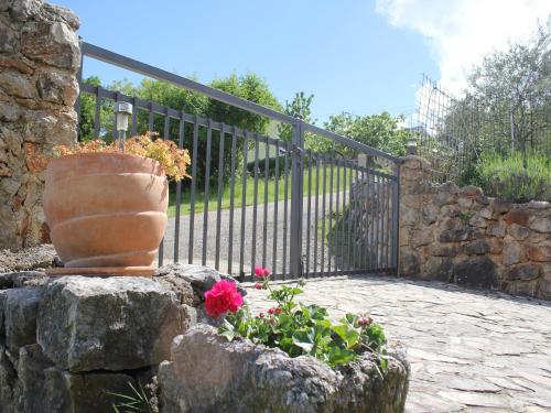 a wrought iron gate with a vase with flowers at Holiday Home with Sea View in Vrbnik