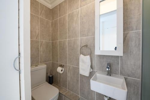 a bathroom with a toilet and a sink at Chakas Cove in Ballito