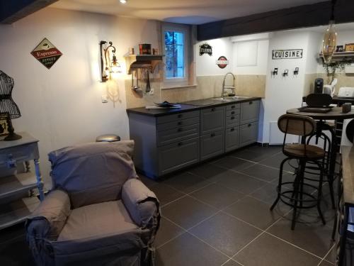 a kitchen with a couch in the middle of a room at Calenco des Carlenes in Tarascon