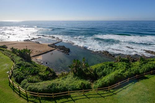 a view of the ocean from a fence at Chakas Cove in Ballito