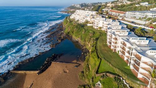 an aerial view of a resort on the ocean at Chakas Cove in Ballito