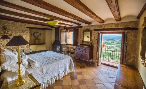 a bedroom with a bed and a large window at Casa Rumbet in Horta de San Joan